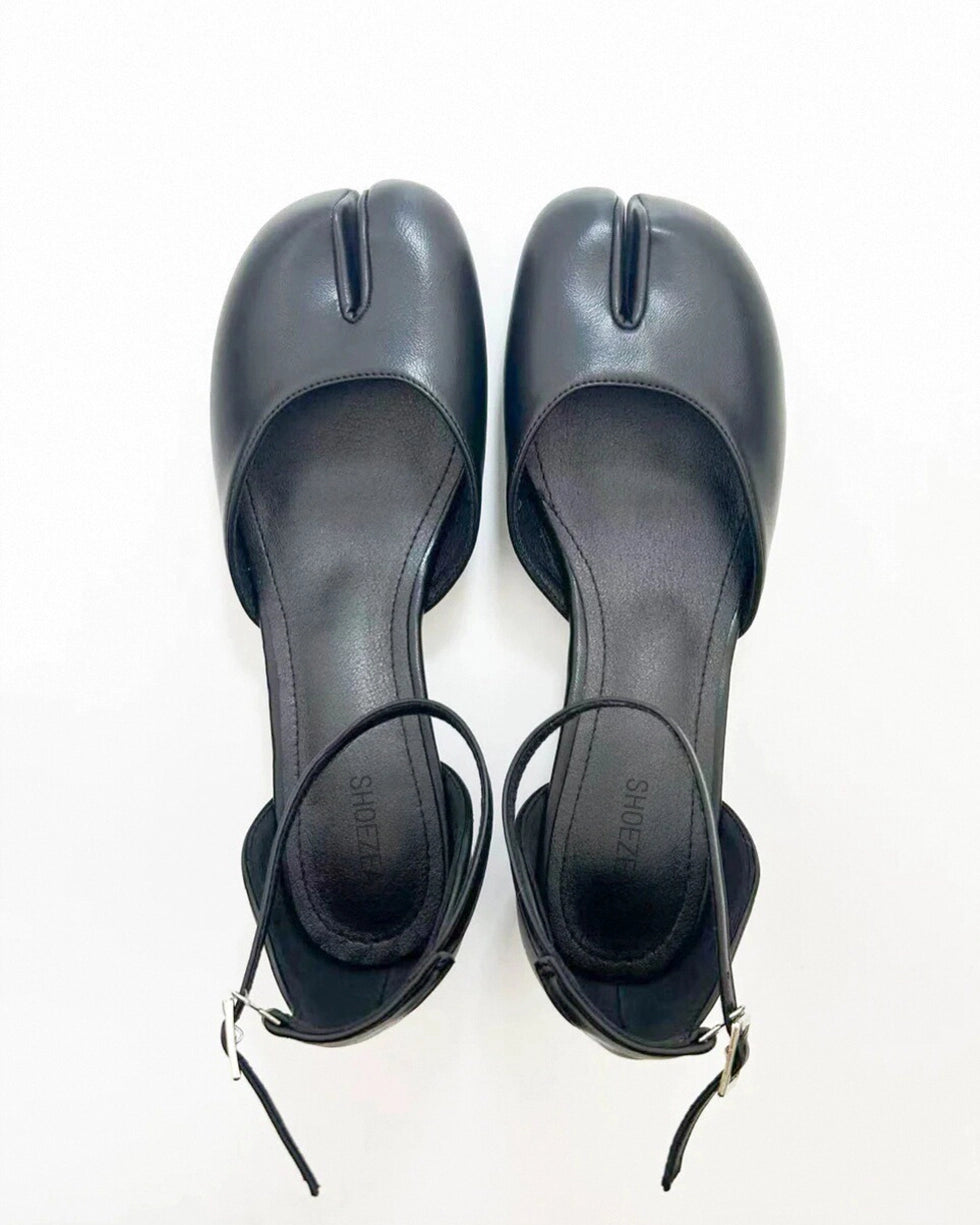 A pair of black Tabi ankle strap sandal pumps with a low heel and microfiber leather upper and lining.