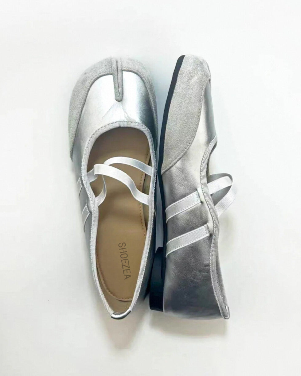 Pair of silver split-toe shoes on a white background Tabi shoes