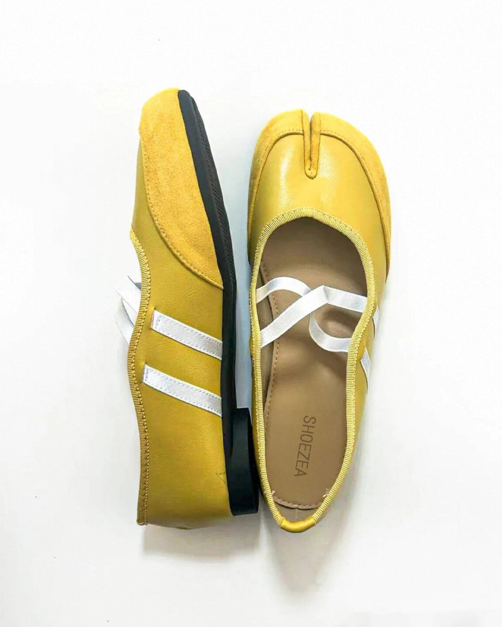 Tabi shoes split-toe shoes Pair of yellow shoes with white stripes on a white background