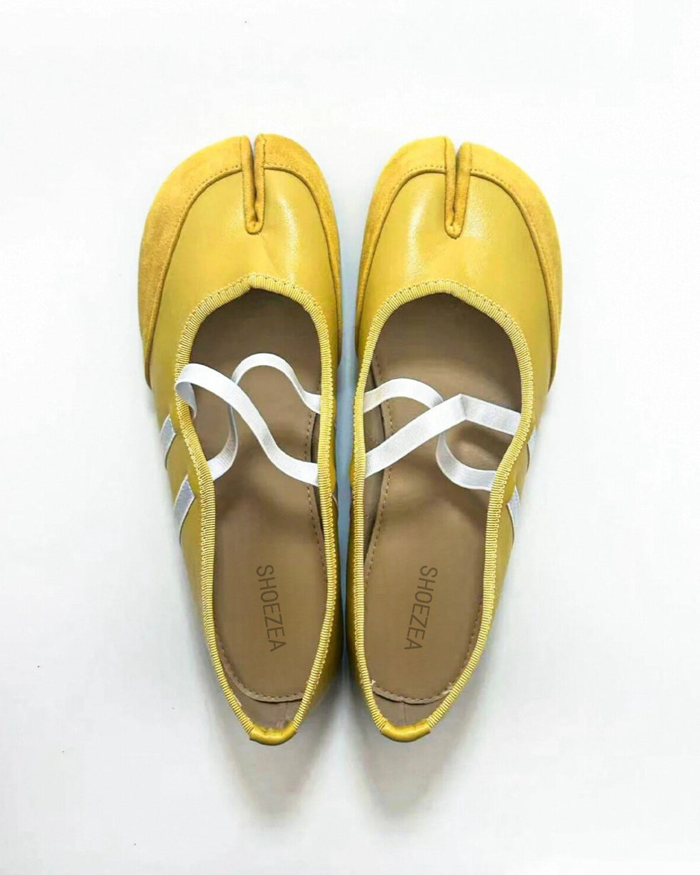 Tabi shoes split-toe shoes Pair of yellow shoes with white soles on a white background